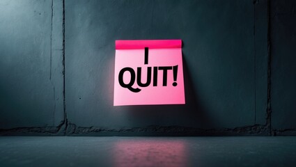 Black text on sticky note on wall stating I QUIT, representing the idea of giving up on tasks or acknowledging defeat, resigning from a job, ending a relationship, or breaking a bad habit like smok...