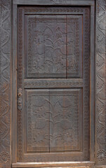 An old wooden door carved with floral motifs in Ciucea village - Romania