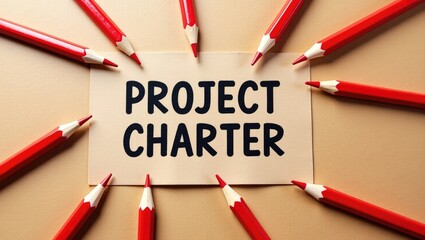 Word text Project Charter memo displayed against a brown craft paper background surrounded by red pencils.