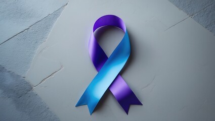 World Arthritis Day. Awareness ribbon in blue and purple on a light grey background, viewed from above.