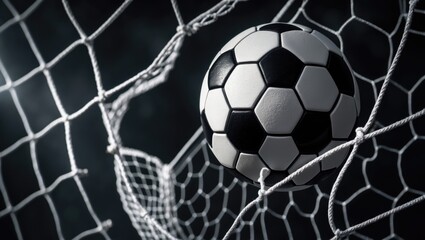 Fototapeta premium Soccer ball successfully in the goal against a background.