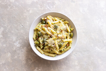 Pasta penne with olives, nuts, herbs and cheese. Healthy food. Italian cuisine. Vegetarian food.