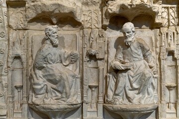 Ancient stone carvings of seated figures.