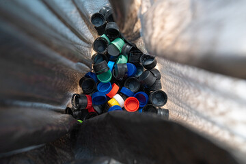 
recycling plastic caps inside a black bag