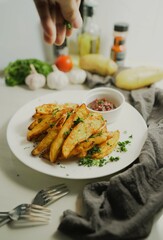 Golden of baked potatoes, seasoned with paprika and garlic, topped with fresh parsley and rich tomato sauce an irresistible homemade dish served fresh from the oven.