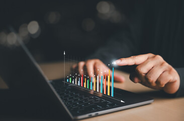 Fototapeta premium Business people analyze a company's financial data and balance sheet by working with digital virtual chart graphics. Businessmen use laptops to calculate financial data for long-term investments.
