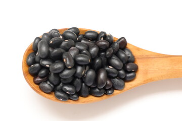 black beans seed with spoon on a white background