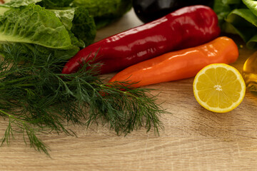 Cut lemon, red pepper.Fresh vegetables for salad in the kitchen.Proper nutrition