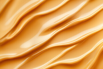 Obraz premium Close-up of smooth peanut butter texture, showcasing creamy waves and rich golden color.