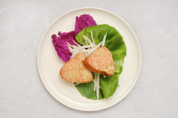 Delicious sesame-coated tuna steaks on vibrant greens and vegetables for a healthy meal