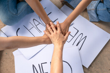 Volunteer holding hands with care stacked huddle together, achieve their ultimate goal.