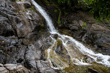 beautiful landscape with a waterfall and mountains and forest on a sunny day in Thailand