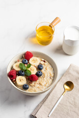 Oatmeal Bowl, Oat Porridge with berries, Banana and nuts in a Bowl, Healthy Snack or Breakfast