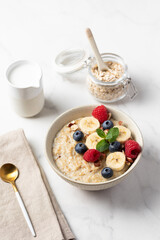 Oatmeal Bowl, Oat Porridge with berries, Banana and nuts in a Bowl, Healthy Snack or Breakfast