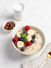 Oatmeal Bowl, Oat Porridge with berries, Banana and nuts in a Bowl, Healthy Snack or Breakfast