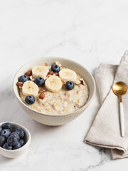 Oatmeal Bowl, Oat Porridge with berries, Banana and nuts in a Bowl, Healthy Snack or Breakfast