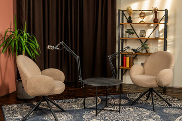 Cozy podcast setup with chairs and microphone for engaging interviews in a stylish room