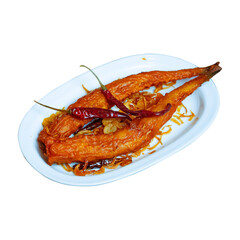 Fried fish with chili peppers and onion on a white plate