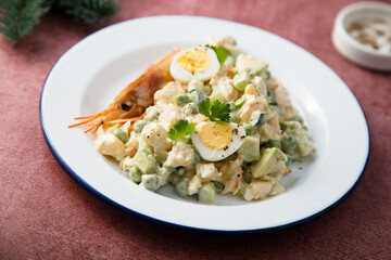 Russian salad with shrimps and avocado