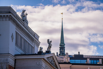 Riga city national opera house rooftop with architecture figures of the roof and towers of church...