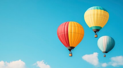 Fototapeta premium Colorful Hot Air Balloons Soaring Against a Bright Blue Sky with White Clouds