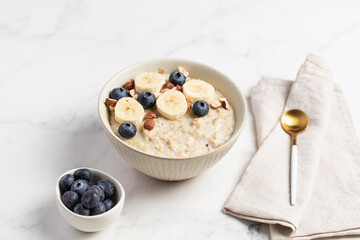 Oatmeal Bowl, Oat Porridge with berries, Banana and nuts in a Bowl, Healthy Snack or Breakfast