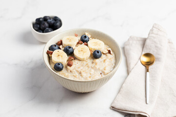 Oatmeal Bowl, Oat Porridge with berries, Banana and nuts in a Bowl, Healthy Snack or Breakfast