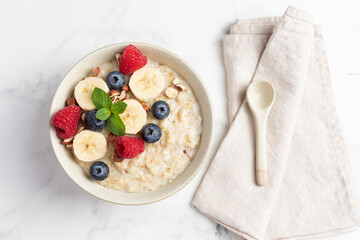 Oatmeal Bowl, Oat Porridge with berries, Banana and nuts in a Bowl, Healthy Snack or Breakfast
