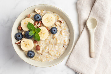 Oatmeal Bowl, Oat Porridge with berries, Banana and nuts in a Bowl, Healthy Snack or Breakfast