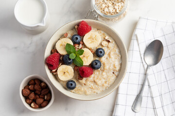 Oatmeal Bowl, Oat Porridge with berries, Banana and nuts in a Bowl, Healthy Snack or Breakfast