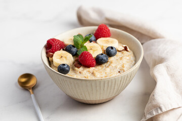 Oatmeal Bowl, Oat Porridge with berries, Banana and nuts in a Bowl, Healthy Snack or Breakfast