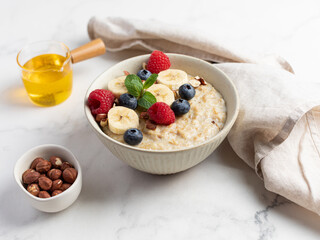 Oatmeal Bowl, Oat Porridge with berries, Banana and nuts in a Bowl, Healthy Snack or Breakfast