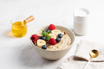 Oatmeal Bowl, Oat Porridge with berries, Banana and nuts in a Bowl, Healthy Snack or Breakfast