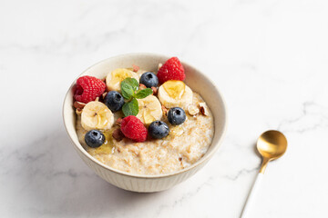 Oatmeal Bowl, Oat Porridge with berries, Banana and nuts in a Bowl, Healthy Snack or Breakfast
