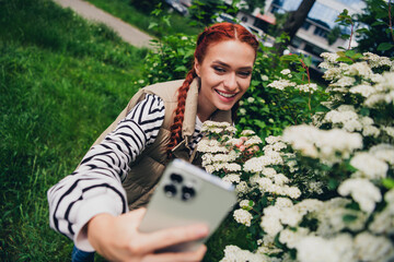 Photo of charming lovely cute girl wear stylish vest jacket hold smartphone take picture sunny...