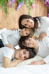 Fototapeta premium Portrait of mother and her children at home in bed