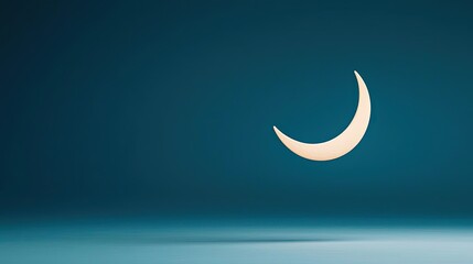 Obraz premium Negative space design abstract background idea. A serene crescent moon against a calming blue background, evoking tranquility.