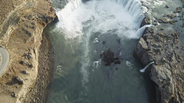aerial footage of golden hour godafoss waterfall in iceland