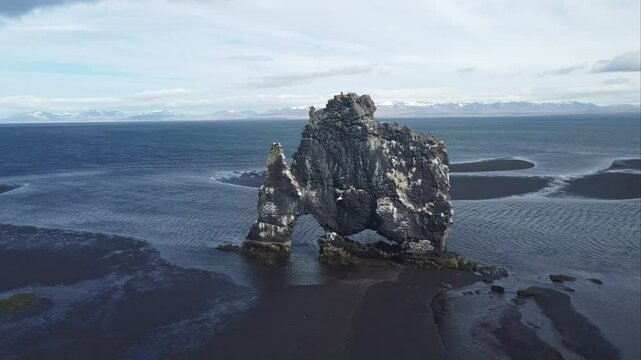 aerial footage of Hvitserkur huge troll stone on iceland shore