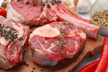 Pieces of raw beef and spices on table, closeup