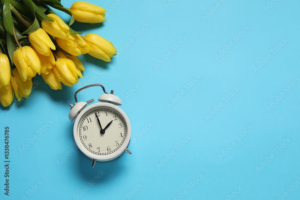 Poster spring time. alarm clock and beautiful tulips on light blue background, flat lay. space for text