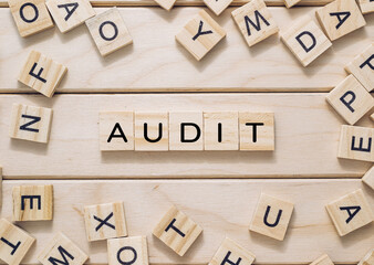 Wooden board with a jumble of letters and numbers scattered across it. The letters spell out the...