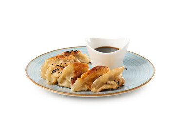Tasty fried gyoza (dumplings) and soy sauce isolated on white