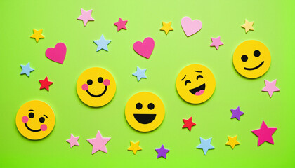 Scattered neon and pastel emoji stickers on a matte lime surface for International Children’s Day