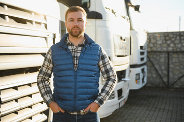 Portrait of confident truck driver on parking lot. Copy space