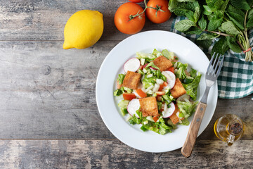 Fattoush salad, Traditional Lebanese Salad on wooden table. Top view. Copy space