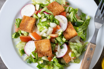 Fattoush salad, Traditional Lebanese Salad on wooden table. Close up
