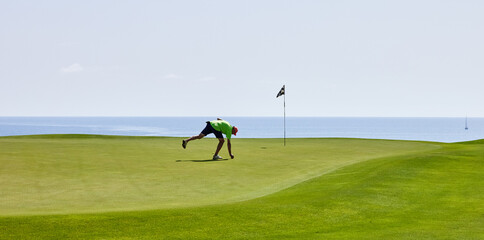 golfer repairs green with pitch lift