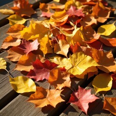 A beautiful autumn background featuring golden leaves scattered across a wooden surface.