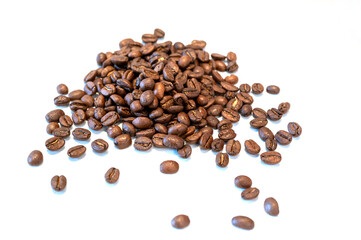 Pile of coffee beans on a white background with copy space, front view.